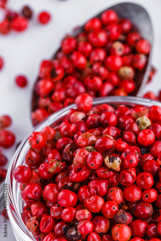 fragrant pink peppercorns on white acrylic background fragrant pink peppercorns on white acrylic background