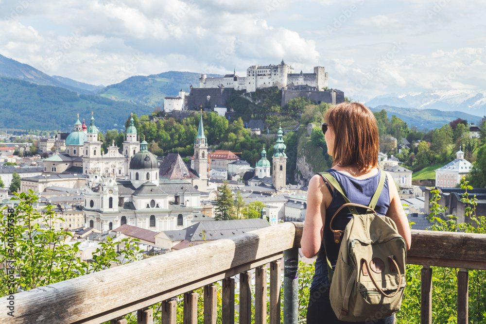 Fototapeta premium Holiday in Salzburg: Young girl is enjoying the view. Historic district, Festung Hohensalzburg
