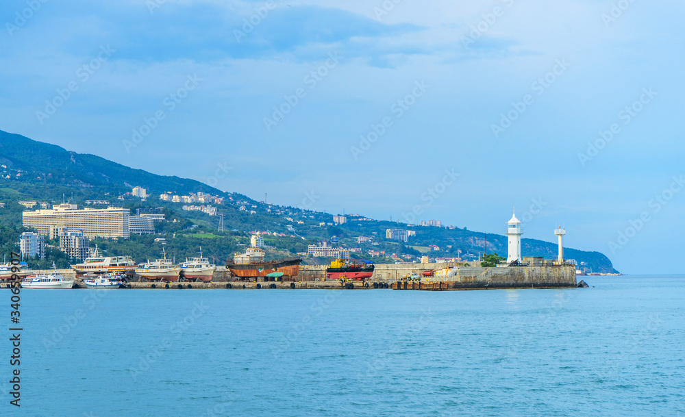 Lighthouse and old ships on the pier in Yalta. Crimea