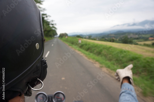 biker driving on a secondary road and enjoying the feeling of freedom