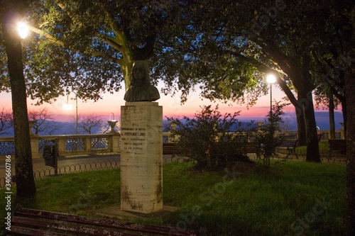 Statue dedicated to Pintoricchio at Perugia Piazza Italia's garden at sunset time