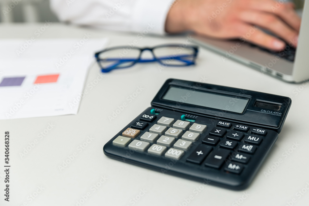 Accounting in office. Man with computer and calculator working with finance. Business concept Accounting in office. Man with computer and calculator working with finance. Business concept