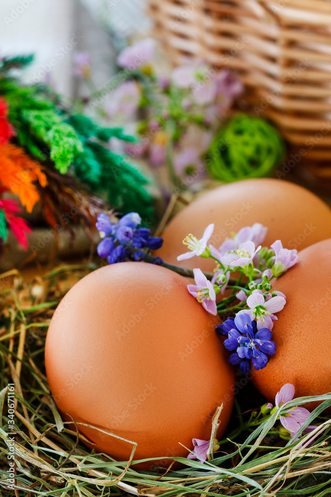 Traditional Easter decoration with eggs, hay and flowers. Traditional Easter decoration with eggs, hay and flowers.