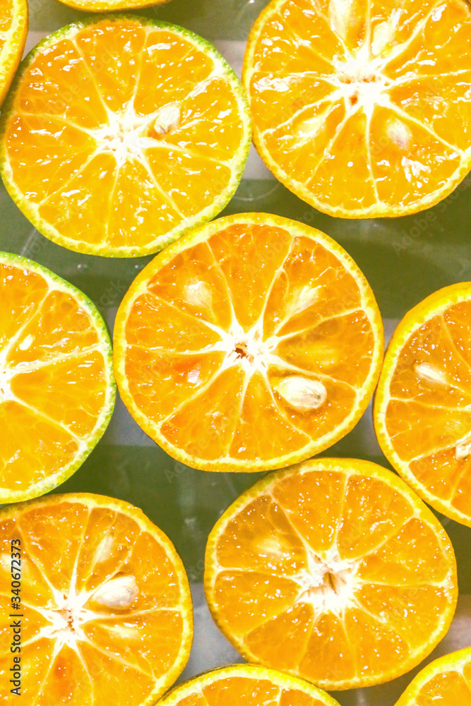 The background of fresh oranges, close-up The background of fresh oranges, close-up