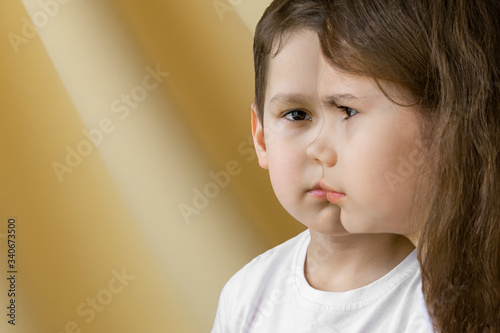 Combined portrait of a girl and a boy in the other side on the yellow background. Concept of Gender dysphoria. Sister and brother concept.