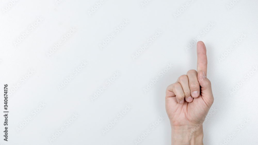 Man pointing at something on white background, closeup of hand Man pointing at something on white background, closeup of hand