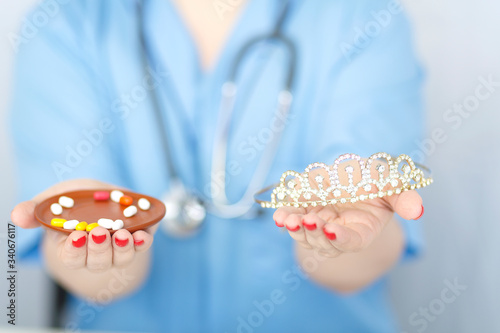 On the palms of a doctor s medicine and crown concept. photo