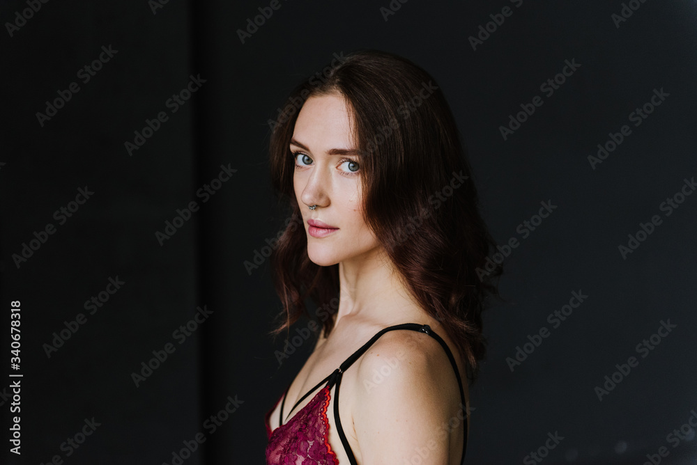 Portrait of a young woman in underwear in a studio. Portrait of a young woman in underwear in a studio.
