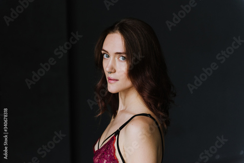 Portrait of a young woman in underwear in a studio.