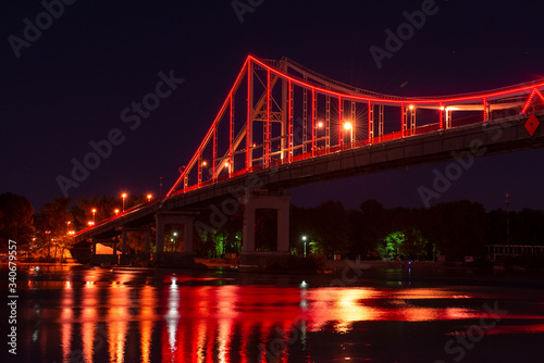 Night view of pedestrian bridge on Dnipro in Kiev Ukraine