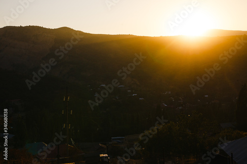 mountain silhoette of austrian alps at sunrise glowing sky