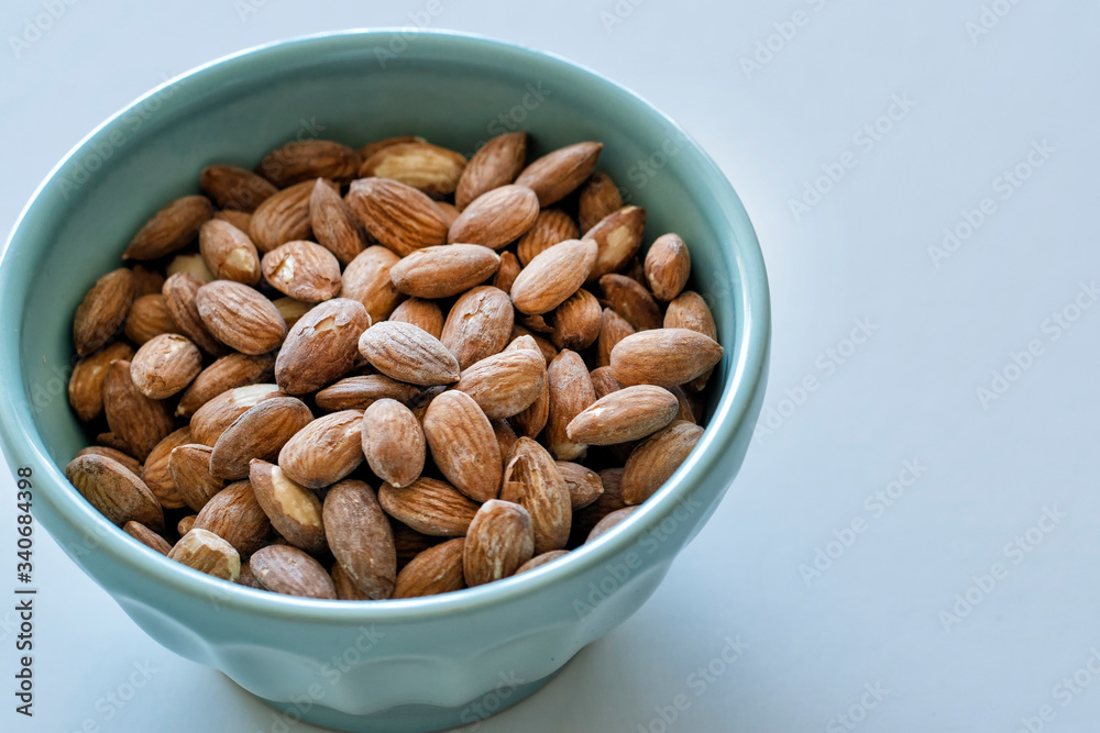 Roasted Almonds in a blue bowl Roasted Almonds in a blue bowl