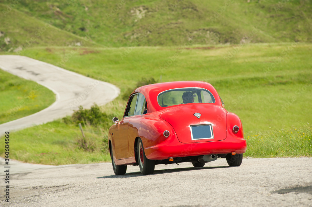 Vintage red car at Mille Miglia italian race