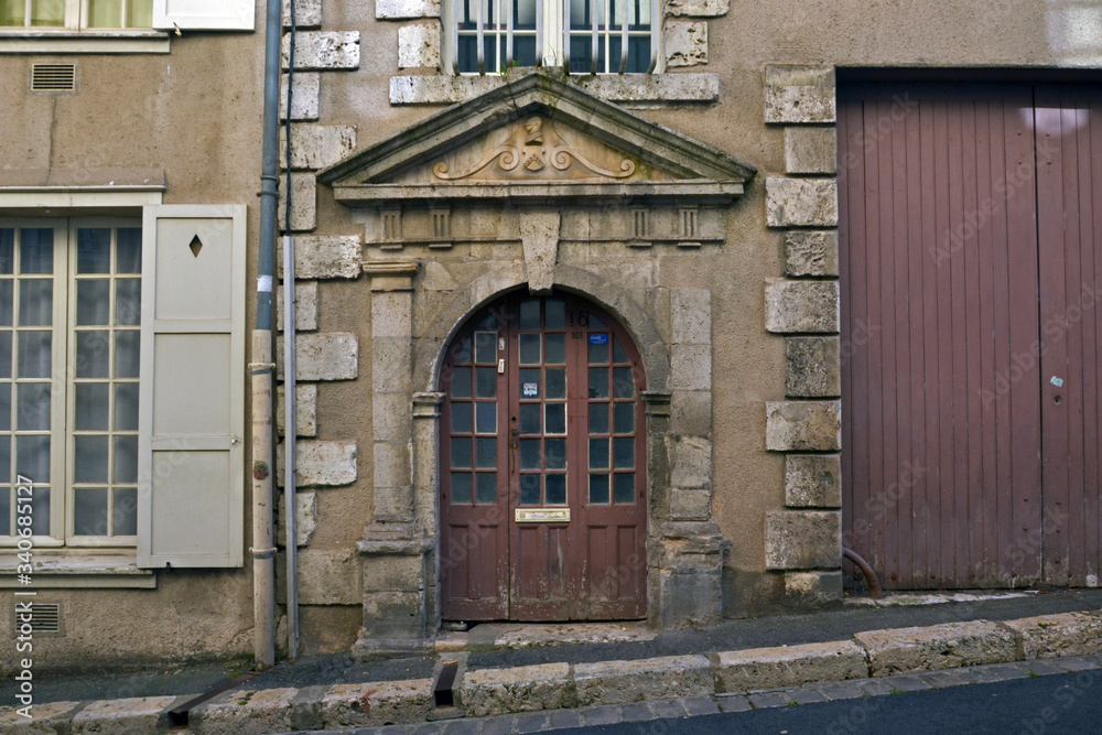 Chartres, France - August 28th 2015 : Focus on a old entry in a street, with sculpted stone. Chartres, France - August 28th 2015 : Focus on a old entry in a street, with sculpted stone.