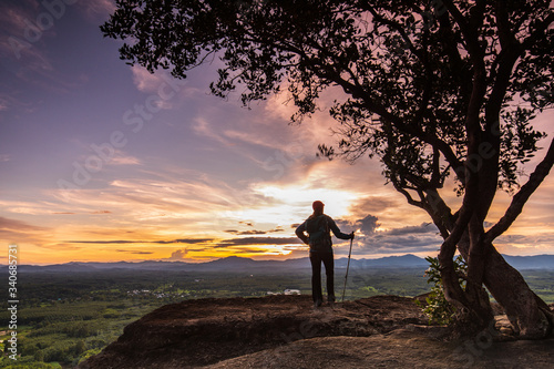 Young woman hiking on Mountain, Pha Daeng viewpoint, Na Yung Nam Som National park, Udonthani province , Thailand.