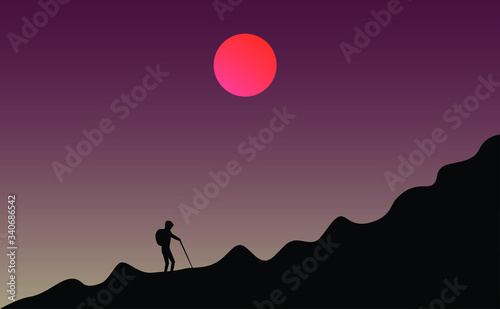 man standing on the top of mountain or a man standing on the top of mountain or man climb the rock, abstract view of dark sky with sun