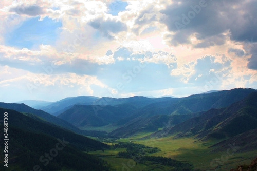 Beautiful landscape with mountains and meadows and clouds. Luxurious views of the beautiful nature untouched by man. Ecologically clean places of the planet. Altai, Chulyshman Valley, Russia