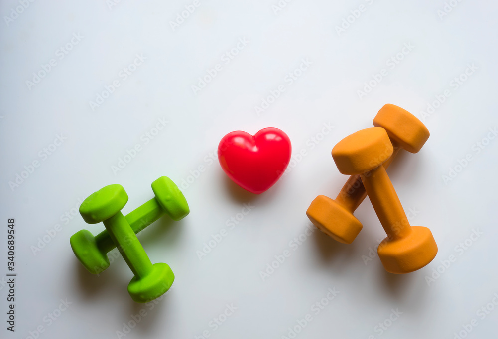 Healthy lifestyle for heart sport dumbbell equipment fitness on white background. Healthy Concept. Top view. Healthy lifestyle for heart sport dumbbell equipment fitness on white background. Healthy Concept. Top view.