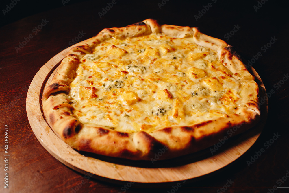 Stock Photo - Fresh delicious Italian pizza  on a dark background