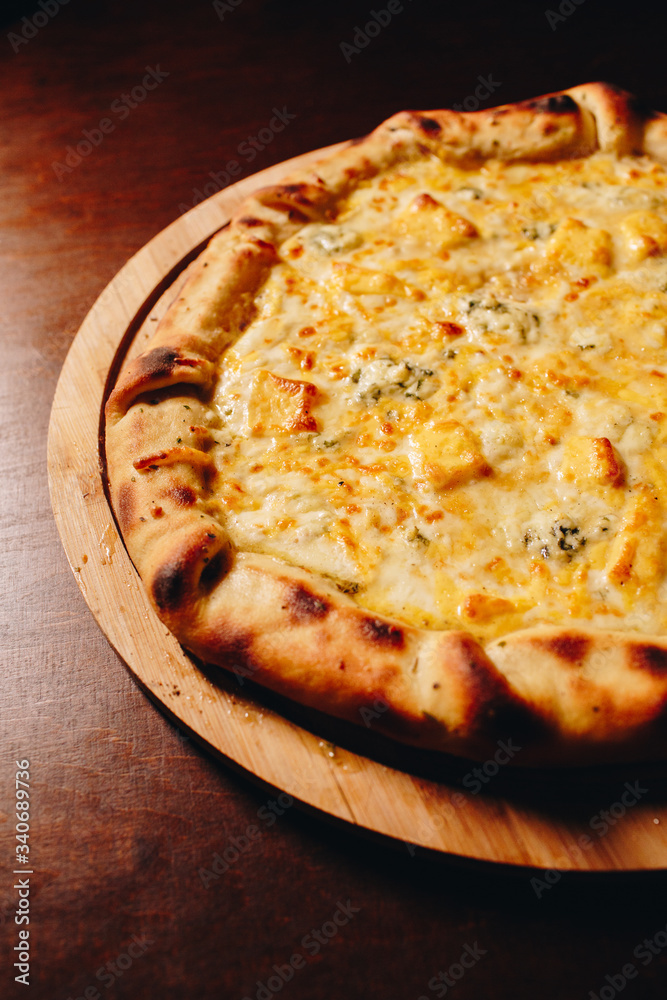 Stock Photo - Fresh delicious Italian pizza  on a dark background