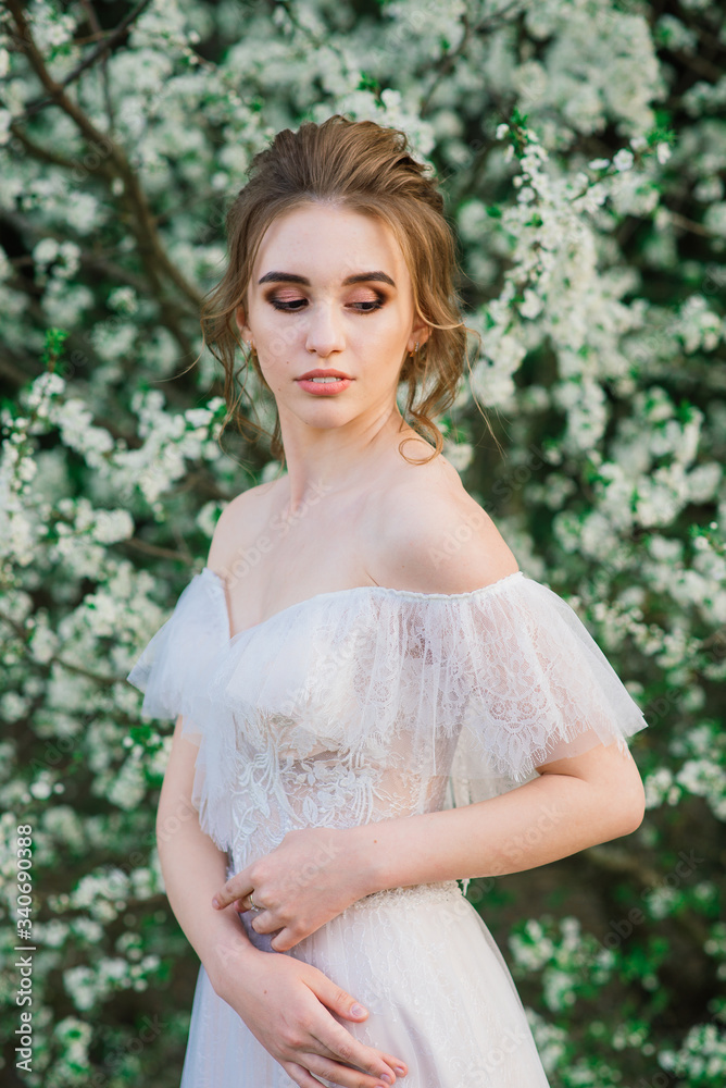 Young beautiful woman in blooming garden. Bride. Young beautiful woman in blooming garden. Bride.