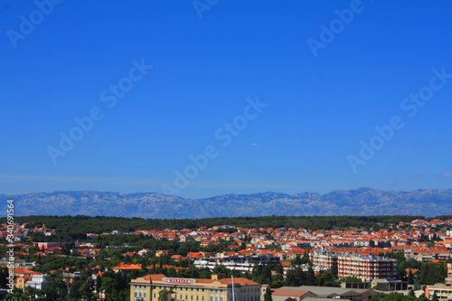 Beautiful view of the rooftops of Zadar from above and the Adriatic Sea. The horizontal landscape of the European city, a clean and beautiful view of the red roofs from a bird's eye view.