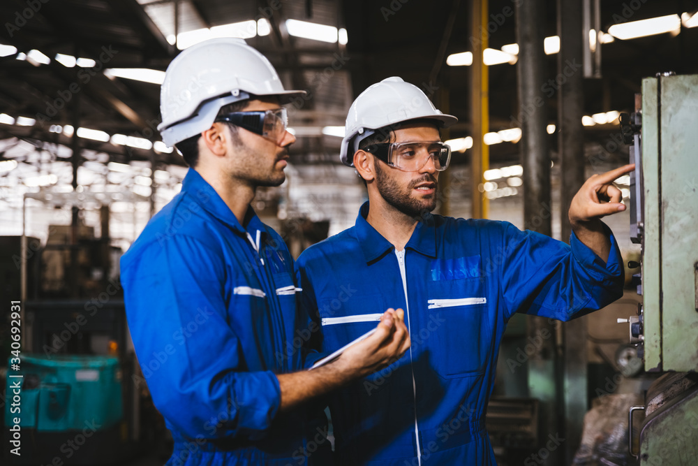 Group of Industrial factory maintenance engineers inspect relay protection system of machinery. Industry, Maintenance, Engineering and construction concept. Group of Industrial factory maintenance engineers inspect relay protection system of machinery. Industry, Maintenance, Engineering and construction concept.