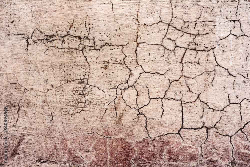 Fototapeta premium Texture of a concrete wall with cracks and scratches which can be used as a background