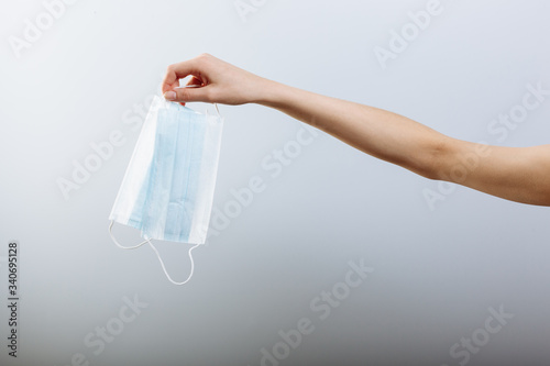 close up of doctor's hand with a medical face mask for protection against infection