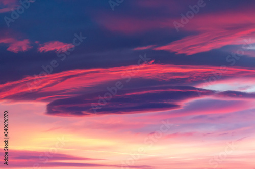 Fototapeta Naklejka Na Ścianę i Meble -  Dramatic sky background in purple, pink and orange hues. Abstract natural sunset skies skyscape, peaceful scenery in vivid colors, horizontal shot