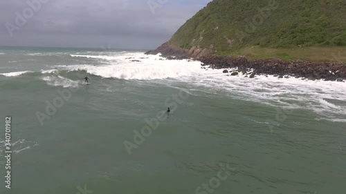 Surfer in a right hander of Silveira Beach, one of the main surf spots in Santa Catarina, Brazil photo