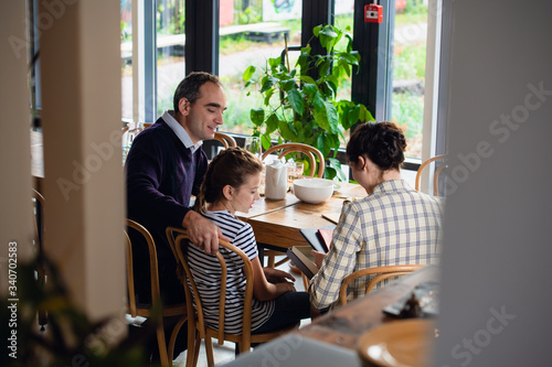 Family spending time together at home, sitting in the dining room