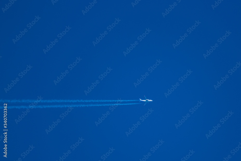 high in the blue sky flies a passenger jet high in the blue sky flies a passenger jet