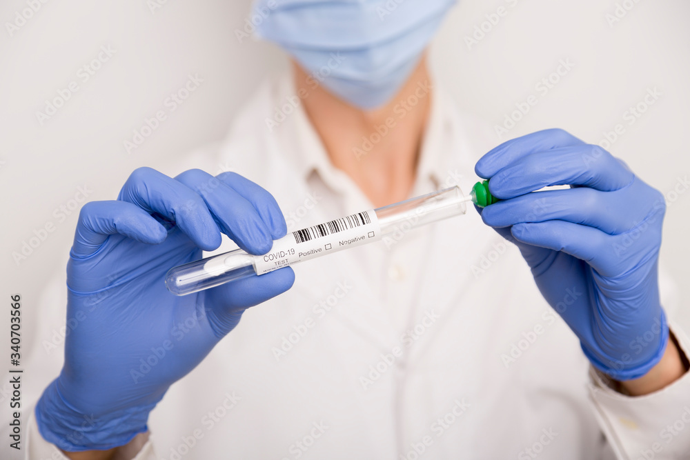 Covid test in the hands of a male doctor with blue gloves Covid test in the hands of a male doctor with blue gloves