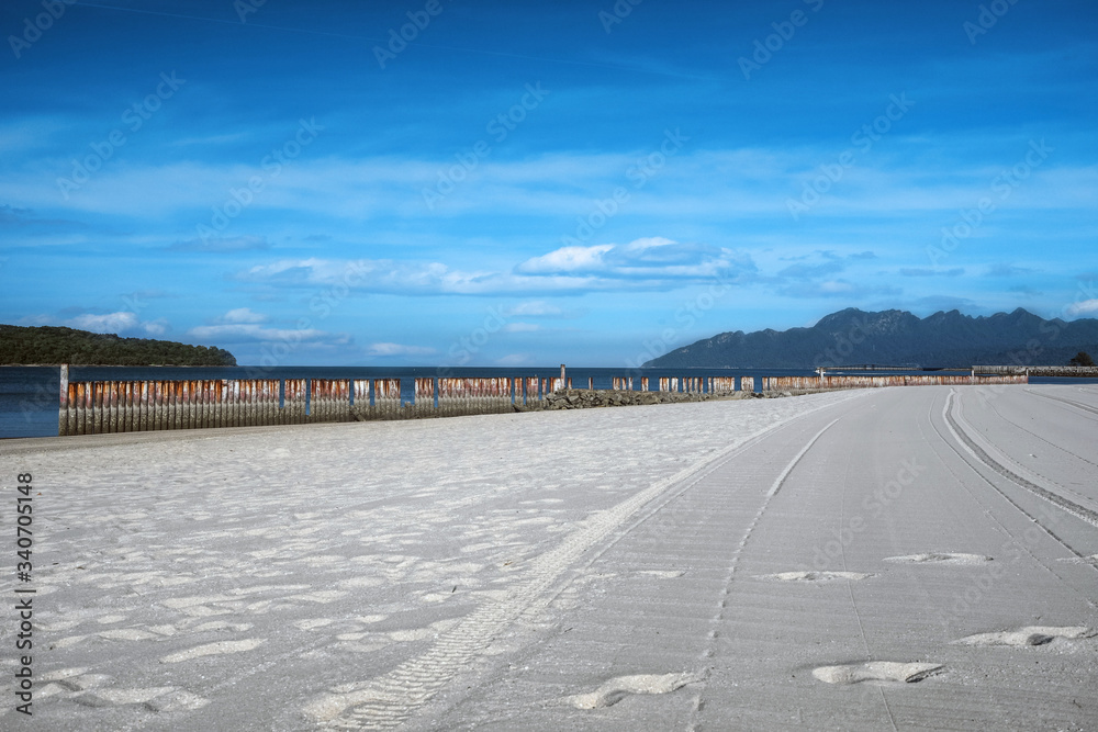 Relaxing holiday on beautiful Tropical sandy beach. Pantai Cenang, Langkawi Island, Andaman Sea, Malaysia Relaxing holiday on beautiful Tropical sandy beach. Pantai Cenang, Langkawi Island, Andaman Sea, Malaysia