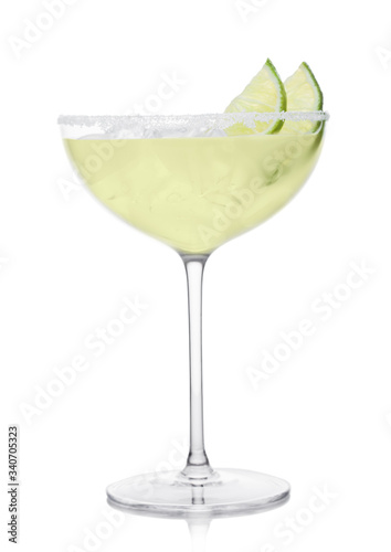 Luxury crystal glass of Margarita cocktail with fresh lime slices on white.