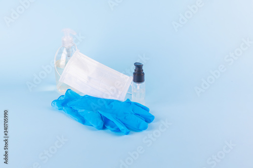 Protective equipment for prevention of virus infection such as hand sanitizer, surgical mask and latex gloves photo