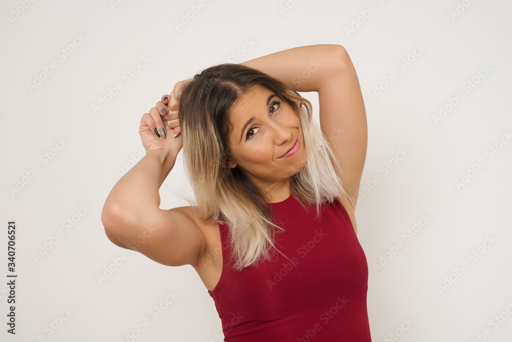 Portrait of beautiful brunette female looks with excitement at camera, keeps hands raised over head notices something unexpected, isolated over gray wall. Lovely woman reacts on sudden news. Portrait of beautiful brunette female looks with excitement at camera, keeps hands raised over head notices something unexpected, isolated over gray wall. Lovely woman reacts on sudden news.