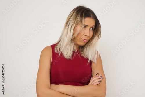 Closeup portrait displeased pissed off angry grumpy pessimistic woman with bad attitude  arms crossed looking sideways. Negative human emotion facial expression feelings