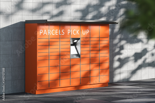 An orange automatic postal terminal self service terminal for receiving parcels standing on the street. Electronic cabinet for storing parcels. Side view. 3d rendering