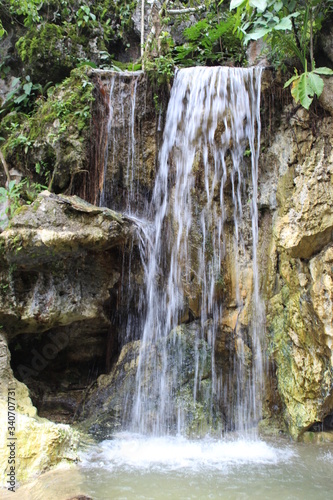 A men walking into the jungle and waterfalls