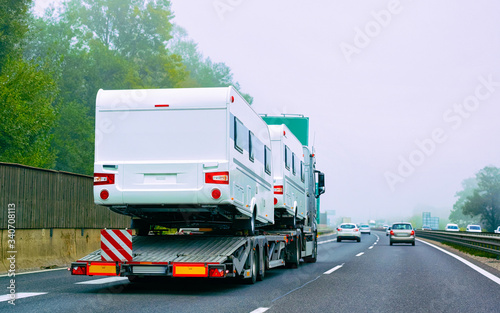 Truck carrier with motor homes rv on road of Slovenia reflex