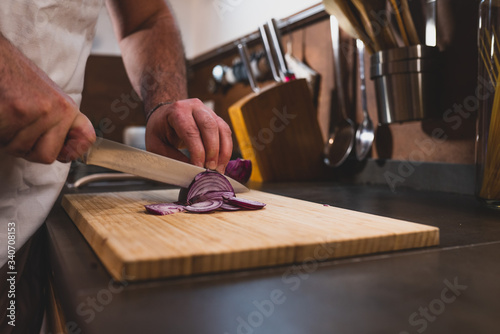 young man cut onion at the home during the lockdown for covid 19