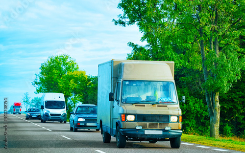 Brown Van at asphalt road Slovenia reflex
