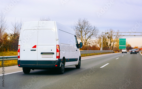 White Minivan on road on driveway van transport reflex © Roman Babakin
