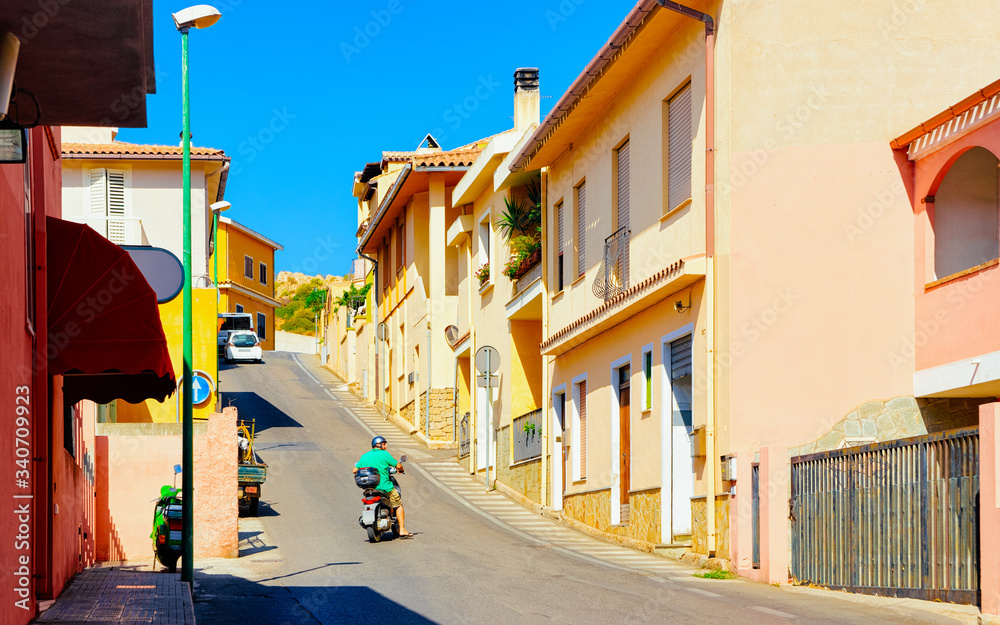 Street view with Scooter on Road in town in Cagliari reflex