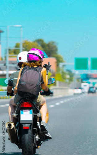 Bikers couple on Motorbike on road in Switzerland reflex