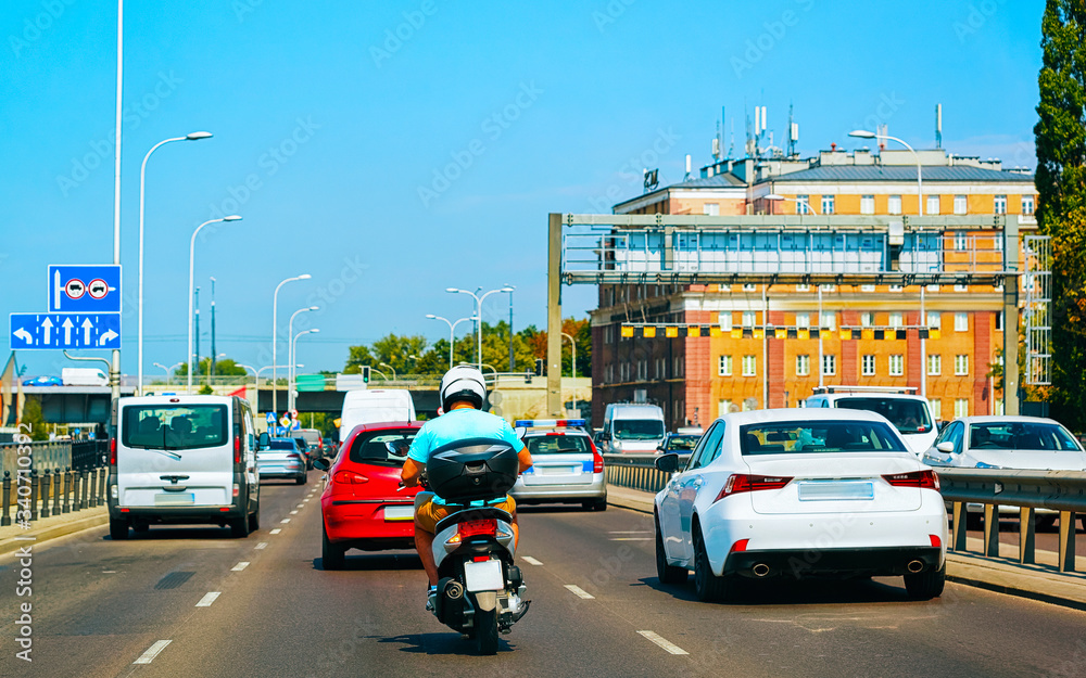 Fototapeta premium Motorcycle and car on road in Warsaw reflex