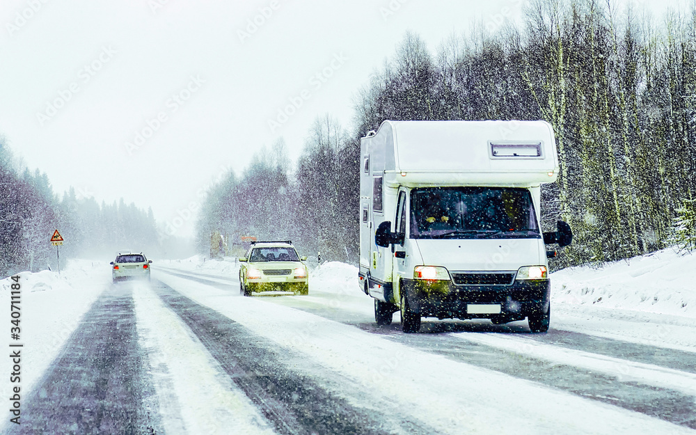 Obraz premium Caravan in road in Rovaniemi Finland of winter Lapland reflex