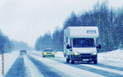 Caravan in road at winter Rovaniemi reflex
